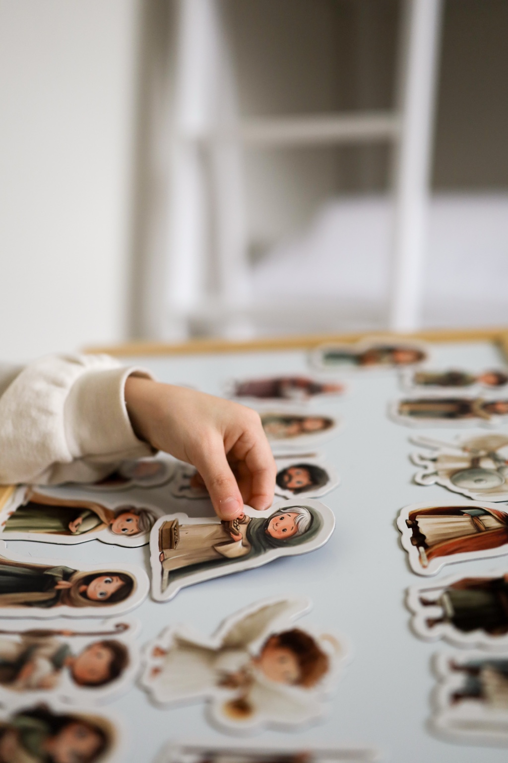 Child interacting with educational character pieces