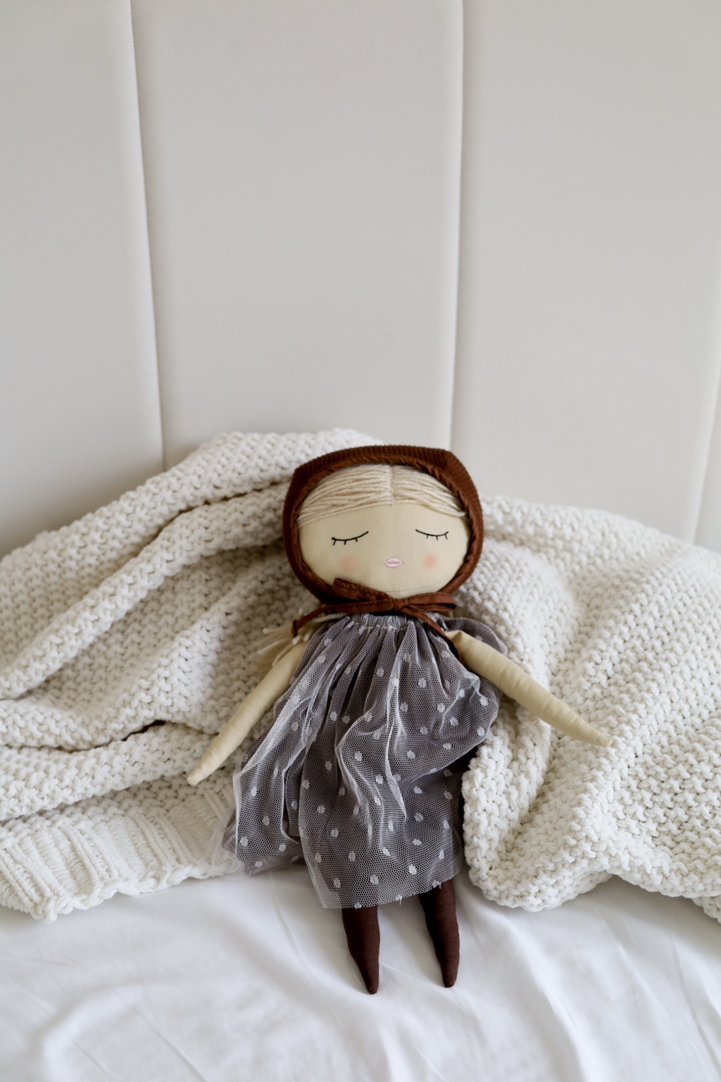 Handmade doll styled on a soft knit blanket