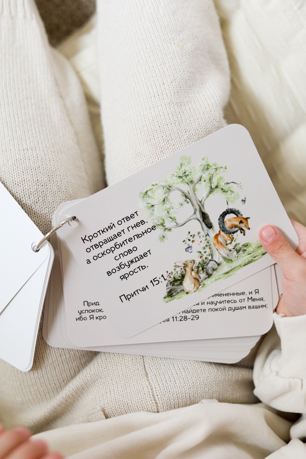 Child holding illustrated scripture cards